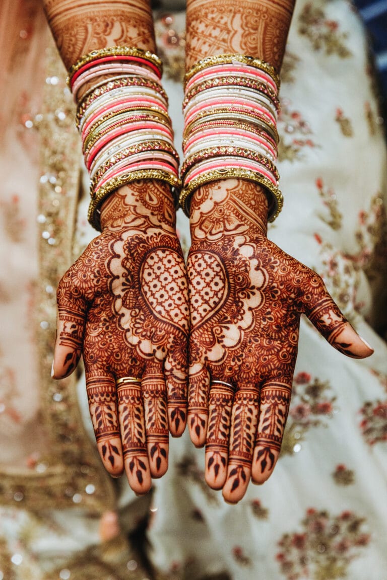 Indian wedding bangles and  mehandi henna coloured hands with r